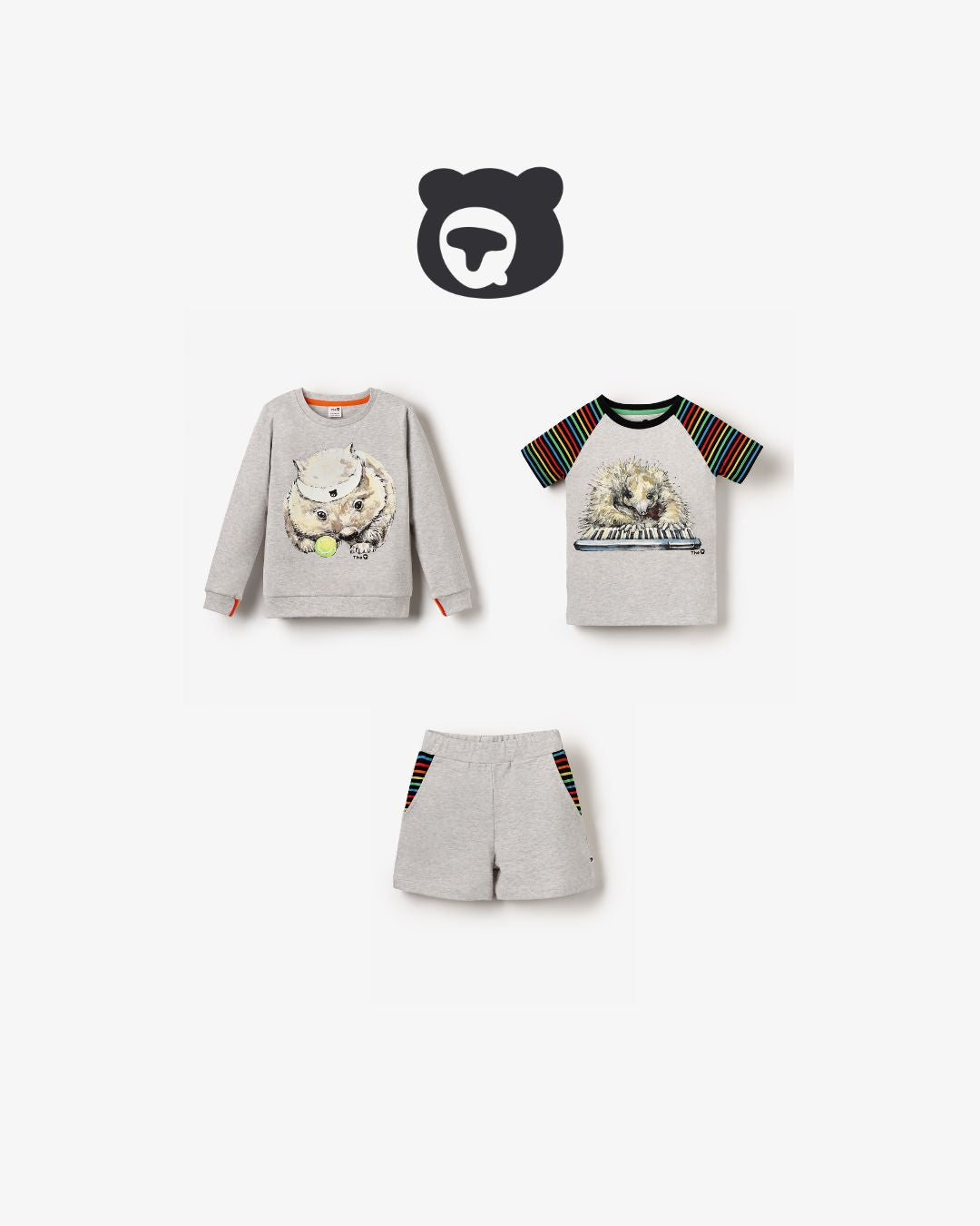 Flat lay of organic kidswear bundle with grey marl Tennis Wombat sweatshirt, rainbow-sleeved Echidna Pianist tee, and grey marl shorts with rainbow trim. Unisex and sustainably made.